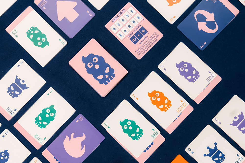 Cacahead cards and rules arranged on a blue game table